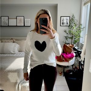 “Loft” white sweater with black centered heart design.